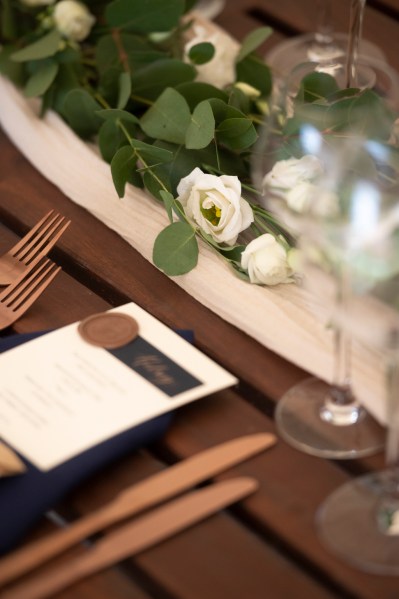 Close up of table white roses wine cutlery